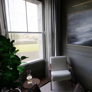 Modern interior with a white armchair, plant, and window view.