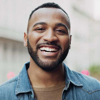Man wearing a denim jacket with a blurred background
