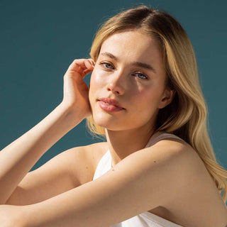 Woman with blonde hair against a clear blue sky