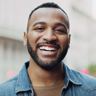 Man wearing a denim jacket with a blurred background