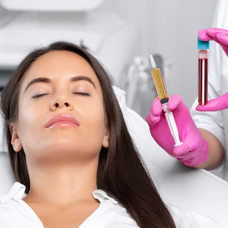 Woman receiving a facial treatment with a syringe and blood sample in the background