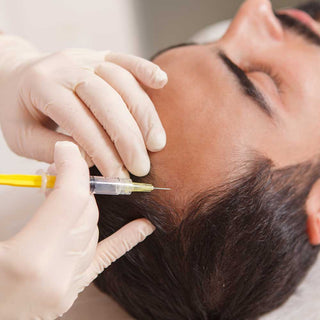 Person receiving a PRP injection with gloved hands