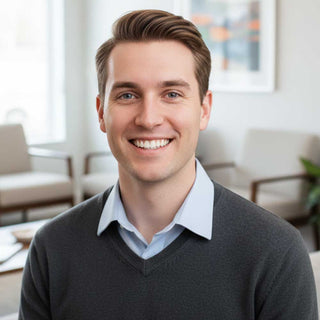 Man smiling in a professional setting with blurred background